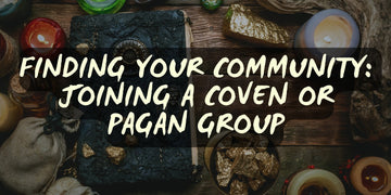 Decorative spellbook, candles, crystals, and gold nuggets arranged on a wooden table for pagan or coven group rituals