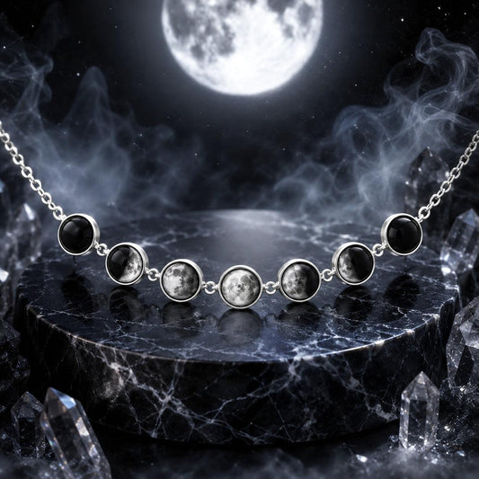 A silver necklace with seven round moon-phase style gemstones displayed on a dark marble pedestal, with a full moon and smoky atmospheric background.