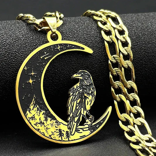 Gold pendant with an raven design on a black background