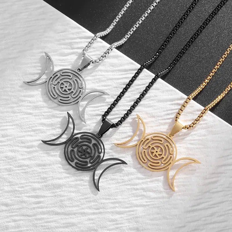 Three stainless steel Hecate Wheel Triple Moon necklaces in silver, black, and gold, showcasing the sacred Wicca design.