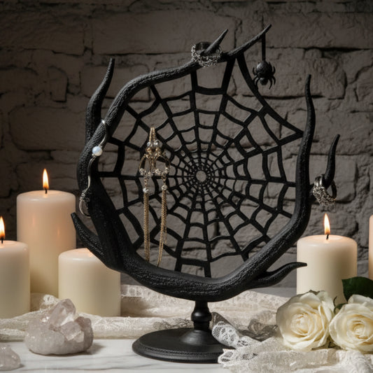 Spider web jewelry stand with earrings and makeup products on a neutral background