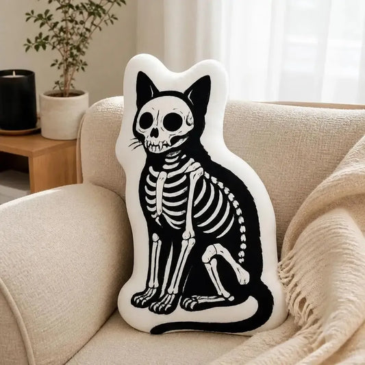 Styled on a sofa: decorative plush pillow featuring skeletal cat illustration