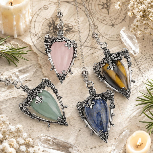 Water drop pendulum locket variants in a bright Pagan ritual scene
