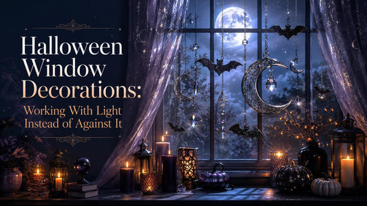 Halloween window decorations with glowing candles, hanging bats, and crescent moons create a spooky nighttime display
