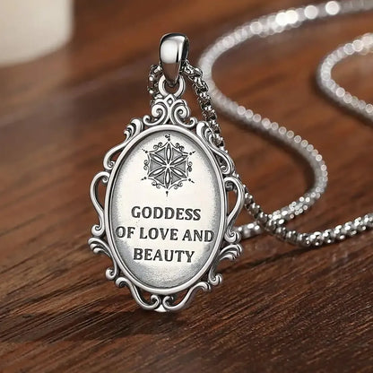 Reverse of Aphrodite necklace with Goddess of Love and Beauty inscription on a wooden surface