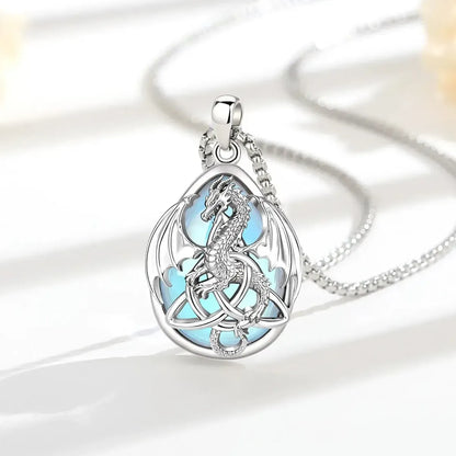 Moonstone Celtic dragon necklace arranged on a sunlit white display surface