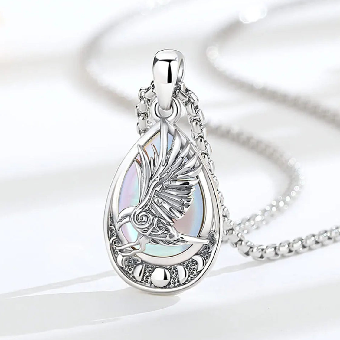 Viking raven rune necklace worn close-up – moonstone crystal Pagan sterling silver pendant