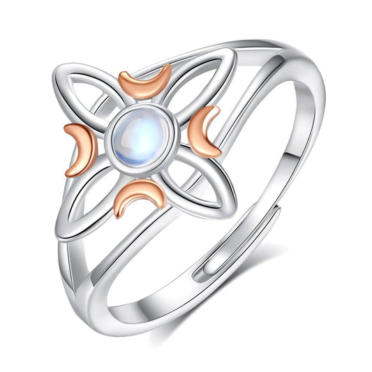 Sterling silver Celtic knot witch ring with rose gold crescent moons and a central moonstone.