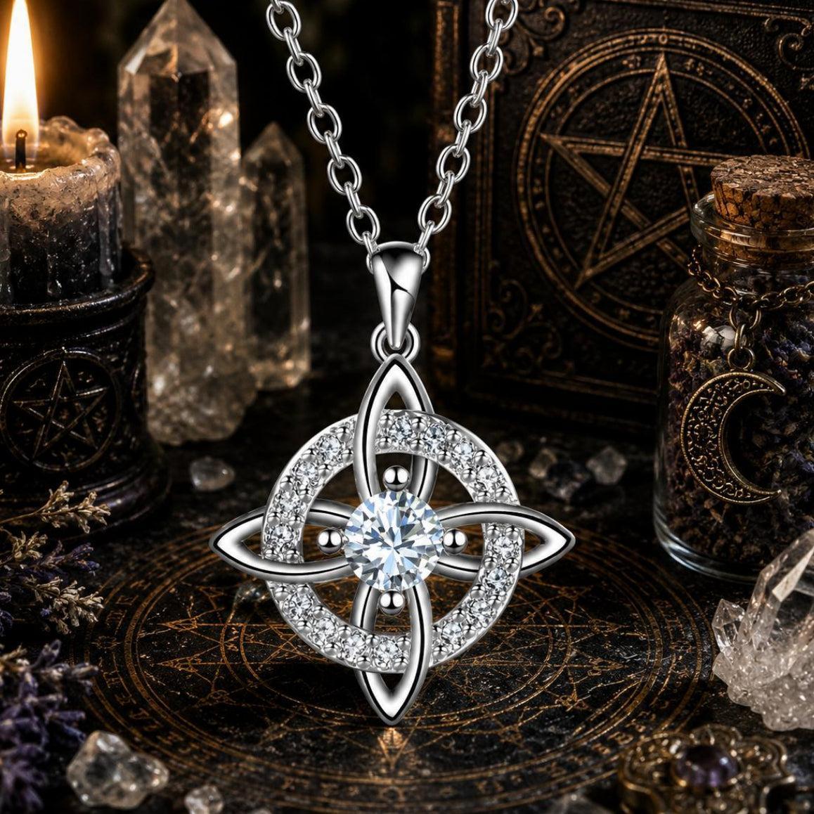 Silver Celtic Witch Knot pendant necklace with crystal, witchcraft altar with candle, crystals, and spell book