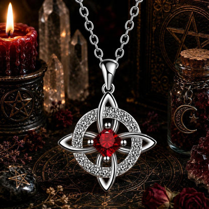 Celtic Witch Knot pendant necklace with red gemstone, crystal quartz, and altar setup for witchcraft rituals