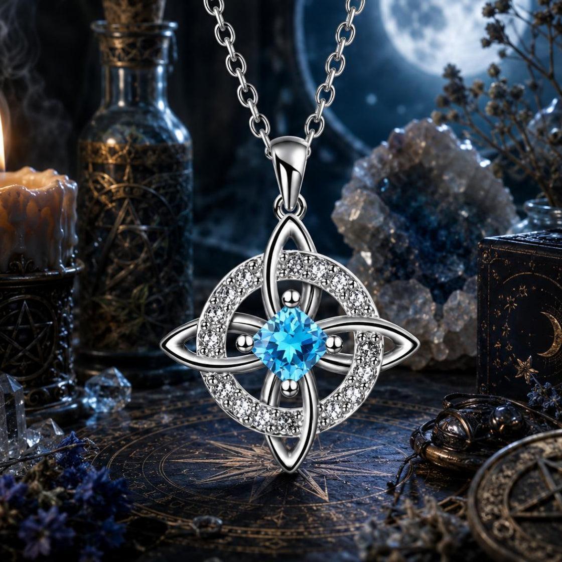 Blue crystal Celtic Witch Knot pendant necklace with witch knot design, surrounded by witchcraft altar items under moonlight