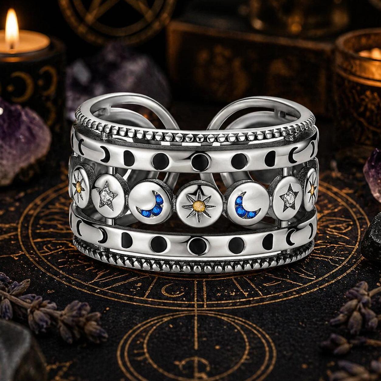 Sterling silver open ring with sun, moon, and stars, featuring blue and yellow accents.