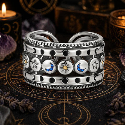 Sterling silver open ring with sun, moon, and stars, featuring blue and yellow accents.