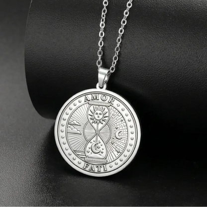 Silver-tone Amor Fati necklace on a display stand