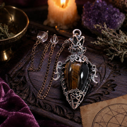 Tiger eye chain water drop crystal pendulum on a Pagan ritual altar