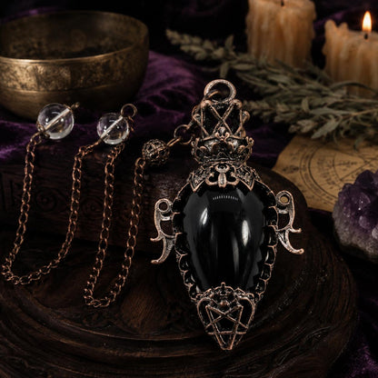 Black agate chain water drop crystal pendulum on a Pagan ritual altar