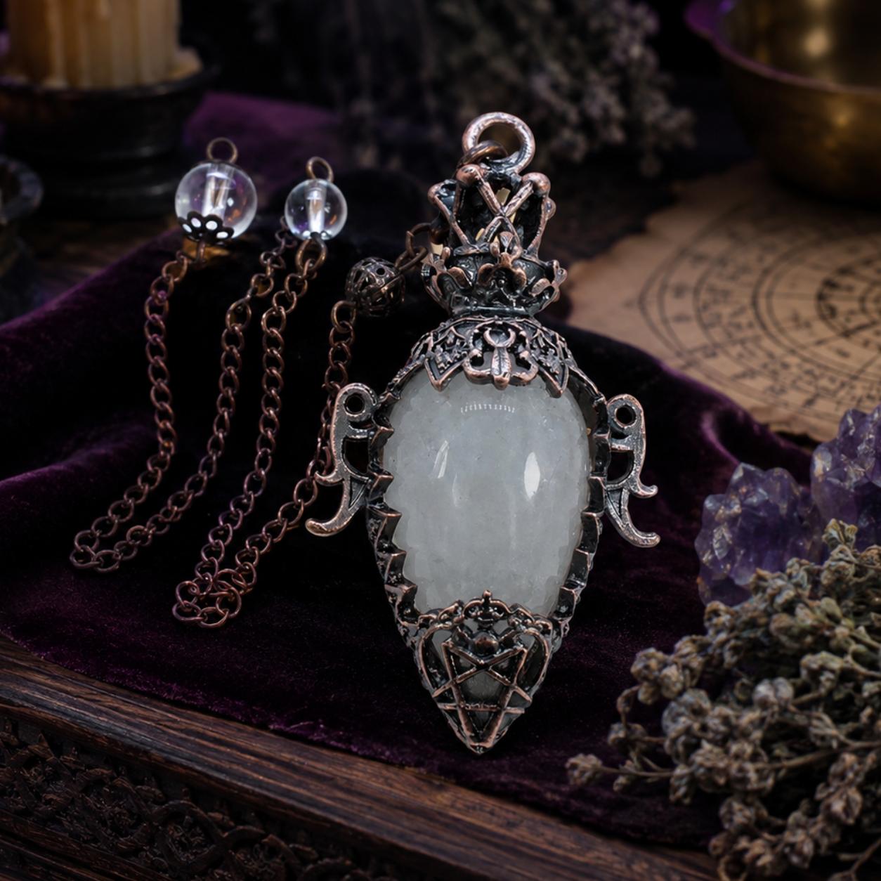 Rock crystal chain water drop pendulum on a Pagan ritual altar
