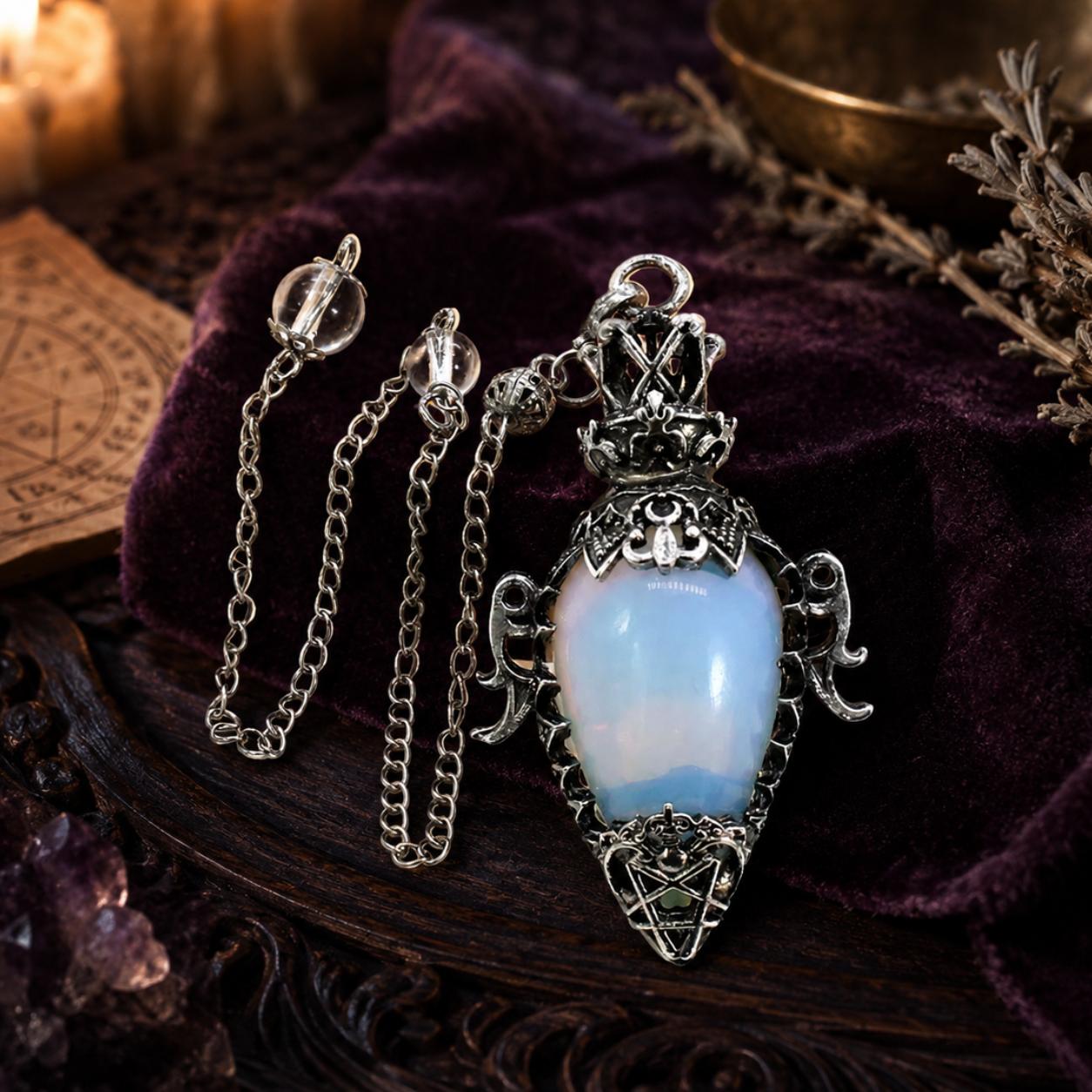 Opal chain water drop crystal pendulum on a Pagan ritual altar