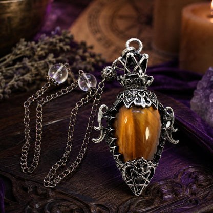 Tiger eye chain 1 water drop crystal pendulum on a Pagan ritual altar