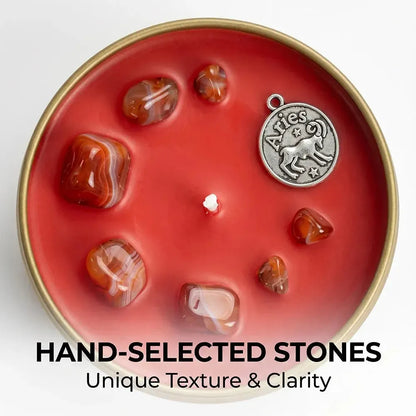 Close-up of Aries Candle red wax with carnelian crystal chunks and an Aries ram charm - Hand-Selected Stones, Unique Texture and Clarity