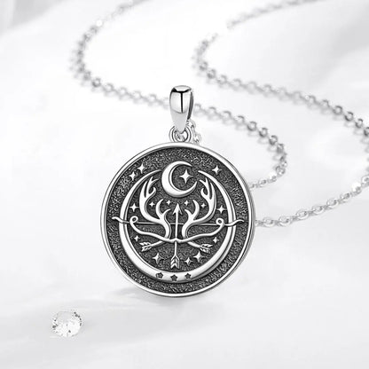 Reverse medallion on pale fabric: Artemis Goddess Necklace in 925 Sterling Silver, featuring Artemis with a bow and deer, framed in an antique-style round pendant.