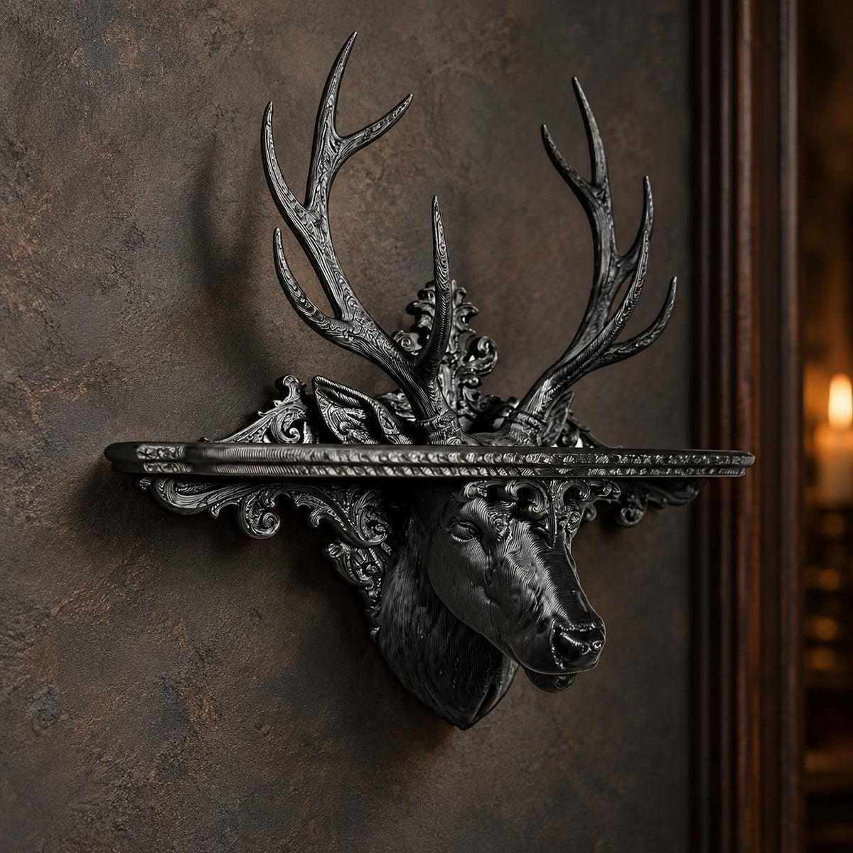 Black baroque stag head wall shelf with detailed antlers and scrollwork mounted on a gothic plaster wall
