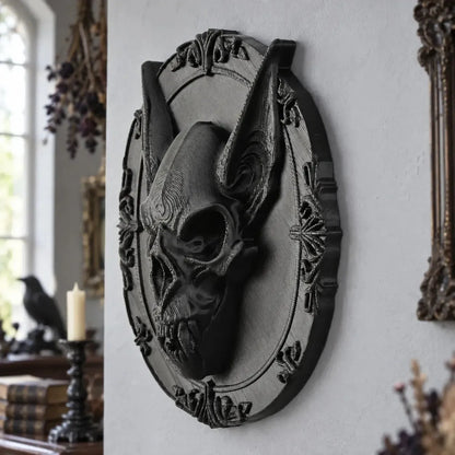 Bat skull wall plaque angled view showing oval baroque border