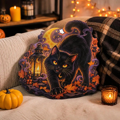 Styled room view: decorative plush pillow featuring black cat with crescent moon and lantern imagery