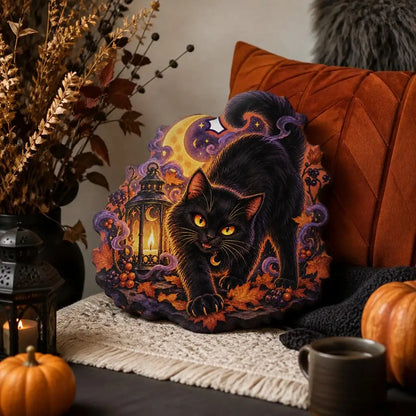 Alternate styled room view: decorative plush pillow featuring black cat with crescent moon and lantern imagery