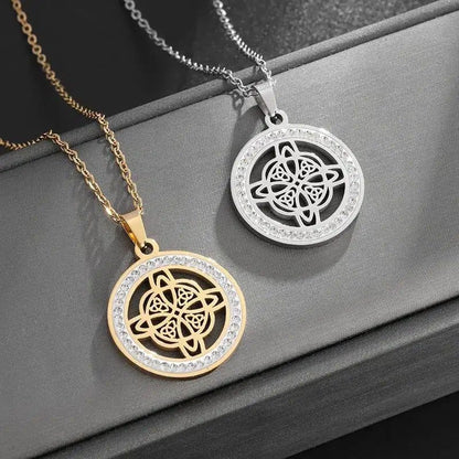 Gold and silver Celtic knot necklaces with clear crystal accents on a dark background.