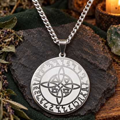Silver-tone Nordic-inspired rune medallion necklace with central interlacing knot in a witchy altar setting