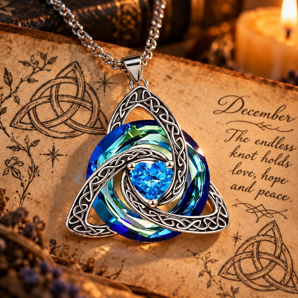 December Celtic Trinity Knot Birthstone Necklace on parchment — The endless knot holds love, hope and peace.
