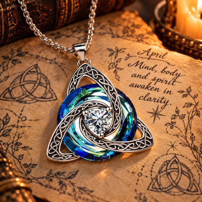 April Celtic Trinity Knot Birthstone Necklace on parchment — Mind, body and spirit awaken in clarity.