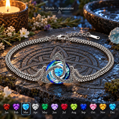 Celtic triquetra aquamarine bracelet on Celtic stone altar with birthstone chart