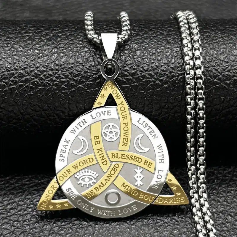 Silver and gold Celtic Trinity Knot necklace with Wiccan symbols and empowering words.