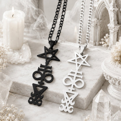 Black and silver Inverted Pentagram Cross necklaces side by side on a white marble surface with a candle, crystal points, and a gothic arch backdrop