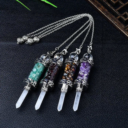 Bottle pendulum collection on dark fabric: Crystal Chip Glass Bottle Divination Pendulum, featuring a crystal-chip glass bottle with an elongated point and chain.
