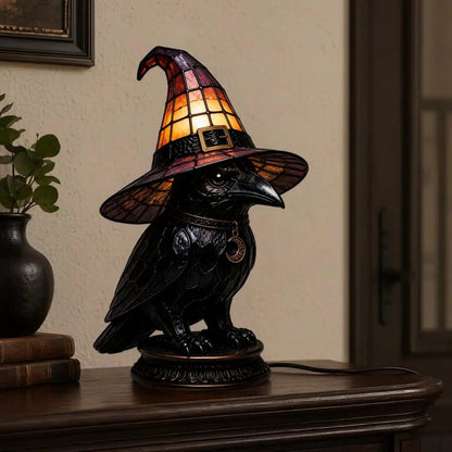 Dark academia raven witch hat night light on entryway table with books and plant
