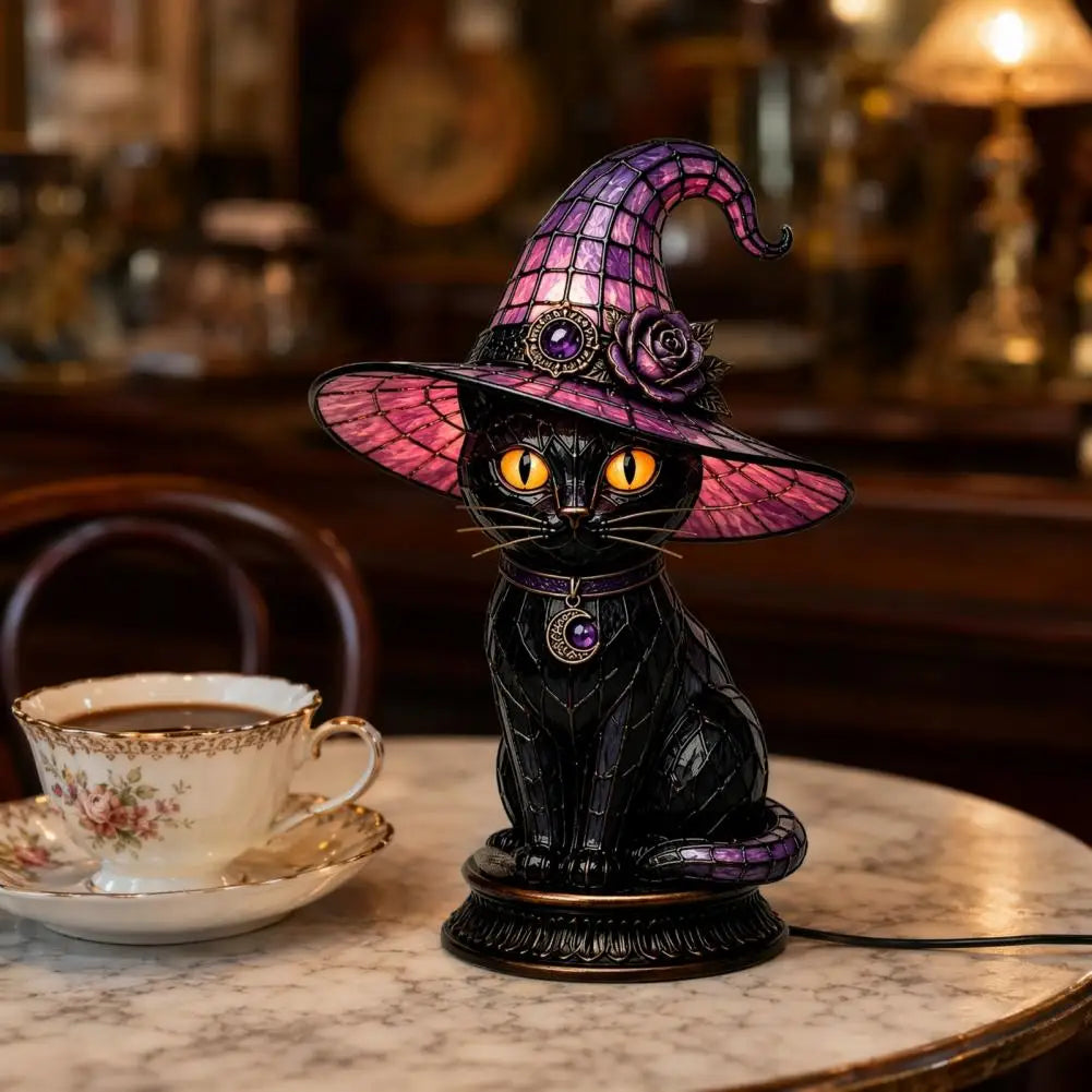 Dark academia black cat witch hat night light on marble table with vintage teacup