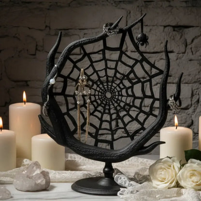 Spider web jewelry stand with earrings and makeup products on a neutral background