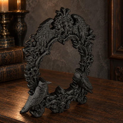 Oblique view of raven rococo open frame on a dark walnut tabletop