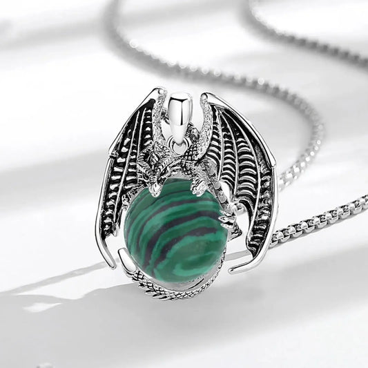 Dragon pendant on pale fabric: Dragon Malachite Ball Pendant Necklace, featuring a winged dragon holding a round malachite stone.