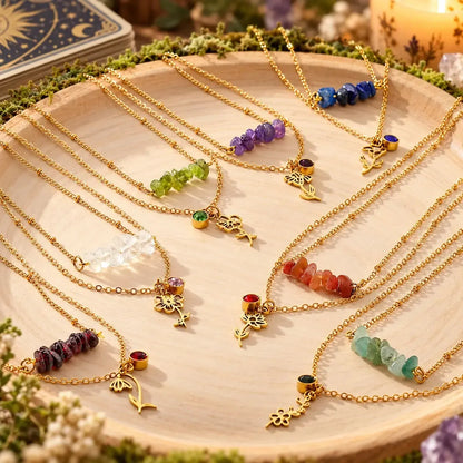 Layered botanical necklaces arranged on a light background