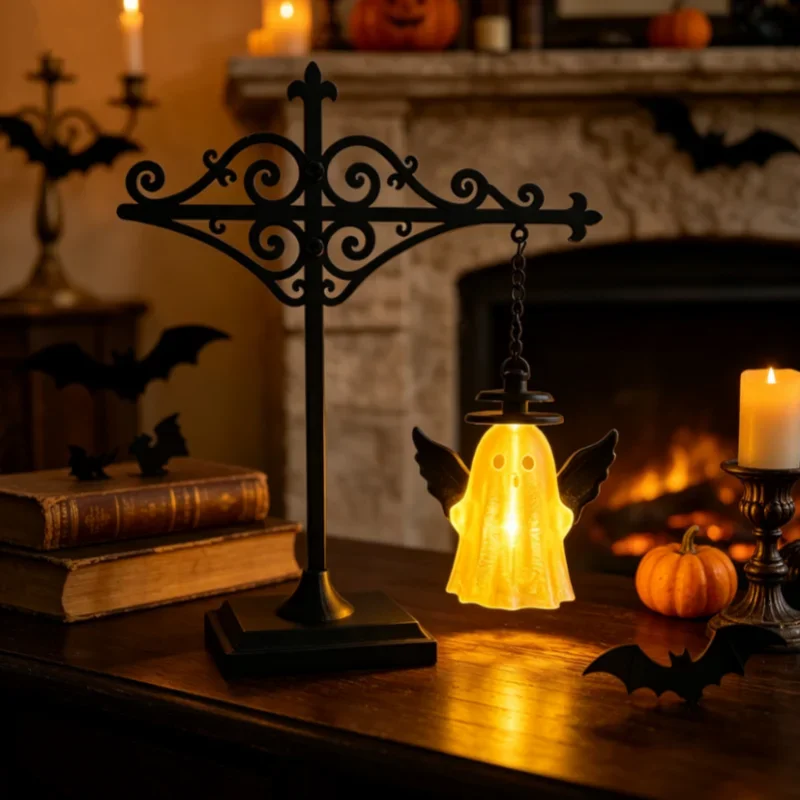 Halloween ghost shaped lantern glowing on mantel with candle and bats