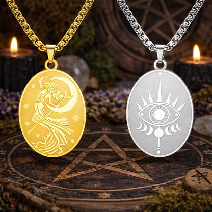 Gold Moon Goddess and silver Eye of Providence oval pendants on chains, on a dark wooden pentagram surface.