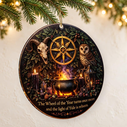 Gold Sun Wheel & Ram Skull Wicca and Pagan Yule Ceramic Ornament – Witchy Christmas Decoration — thin double-sided ceramic ornament, left angled hanging view.