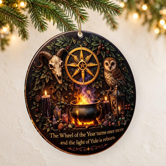Gold Sun Wheel & Ram Skull Wicca and Pagan Yule Ceramic Ornament – Witchy Christmas Decoration — thin double-sided ceramic ornament, left angled hanging view.
