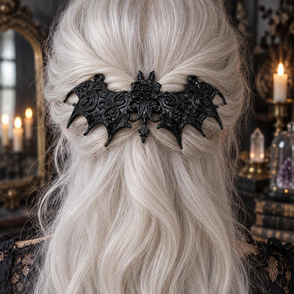 Baroque bat hair clip in white hair worn by a witch in a candlelit mystical room
