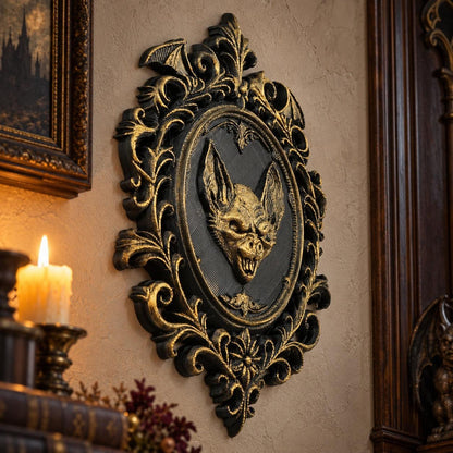 Angled view of bat relief: Gothic Bat Relief Wall Plaque, featuring a central bat relief, an oval medallion and elaborate Victorian scrollwork.