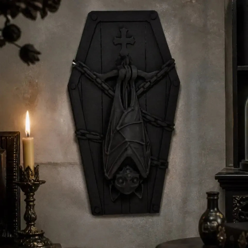 Coffin-shaped plaque with hanging bat displayed on a gothic wall